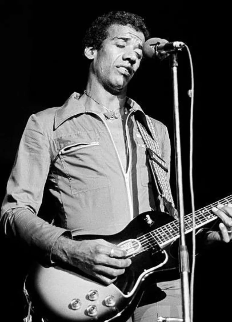 Jorge Ben playing an electric guitar on stage